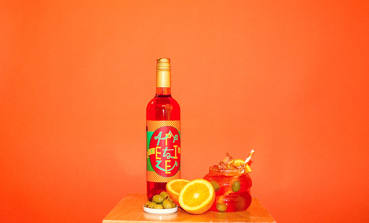 Muni Appetizer aperitif bottle against an orange background