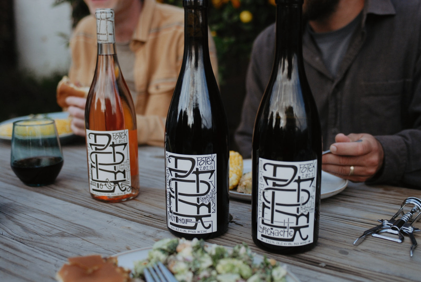 Potek wine bottles on an outdoor table
