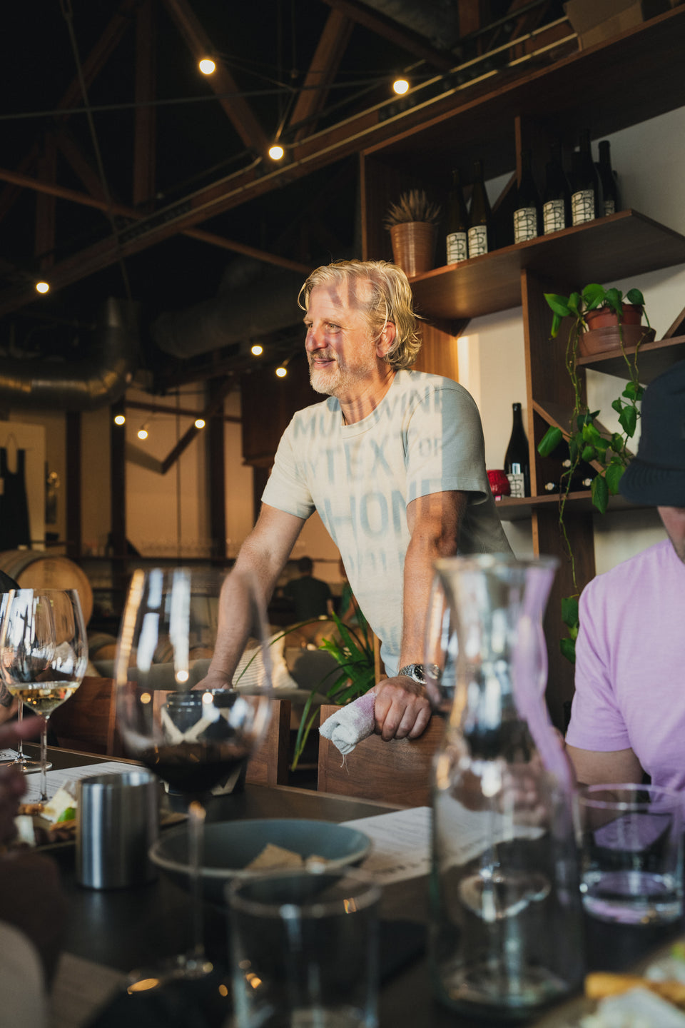 A conversation around the tasting table at Potek, with wine glasses in warm afternoon light.