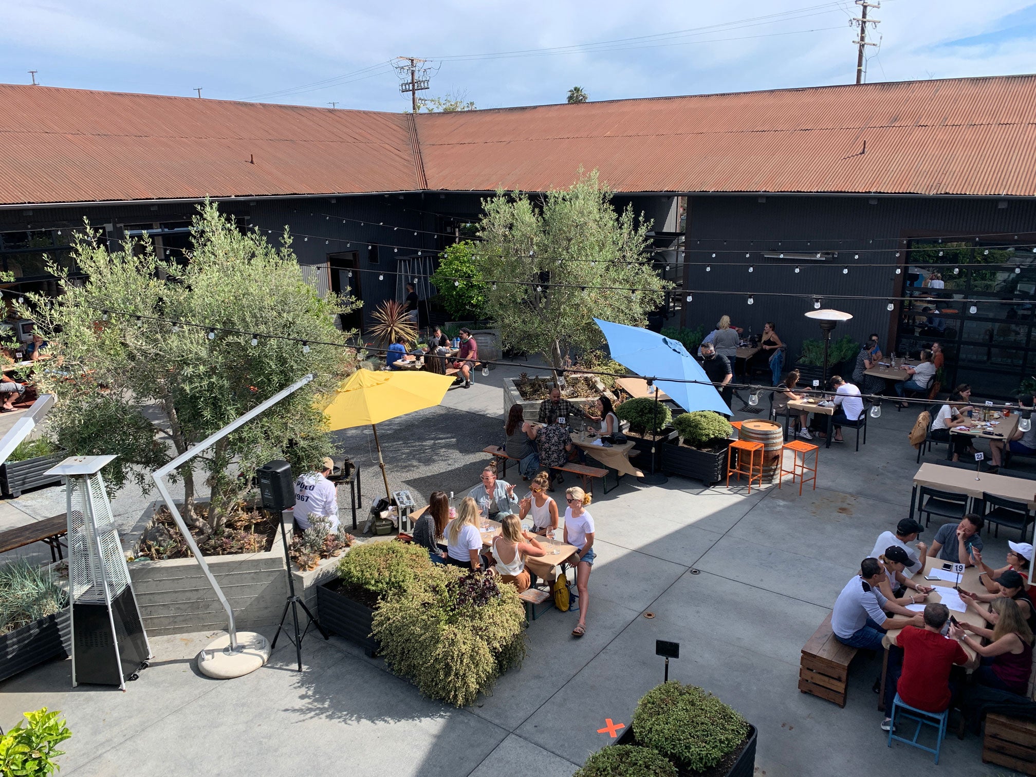 Guests enjoying wine on the outdoor patio at Municipal Winemakers tasting room